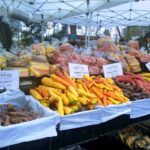 Carrots and root vegetables on display at market stall